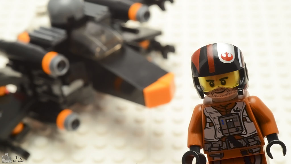 Poe Dameron minifigure with his LEGO X-Wing in the background