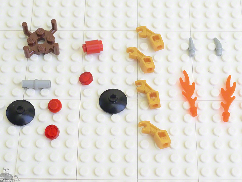 LEGO pieces used to make the flame star spinner laid out on a LEGO plate